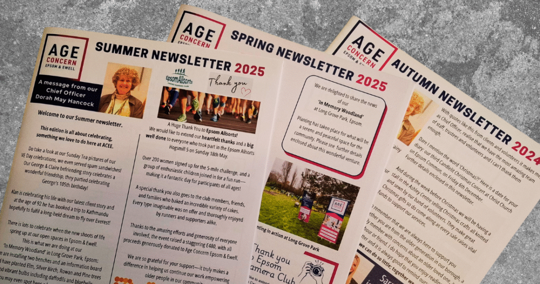 Selection of Age Concern Epsom & Ewell Newsletters on a grey table.